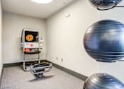 Thumbnail 8 of 24 - A room with a Pilates reformer and a large exercise ball.