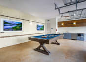 Thumbnail 15 of 35 - a games room with a pool table and a painting on the wall