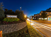 Thumbnail 24 of 24 - A sign that says "The Apartment" is on a grassy area next to a road.