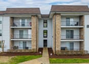 Thumbnail 2 of 25 - a picture of an apartment building with white siding and a brown roof