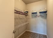 Thumbnail 8 of 18 - an empty closet with two shelves and two baskets on a rack