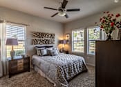 Thumbnail 6 of 18 - a bedroom with a large bed and a ceiling fan