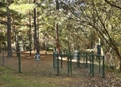 Thumbnail 25 of 27 - a dog park with a green fence and trees at Thornblade, South Carolina, 29615