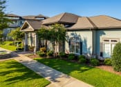 Thumbnail 34 of 37 - a home in a neighborhood with green lawns and trees