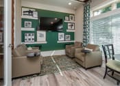 Thumbnail 9 of 37 - a living room with couches and chairs and a television