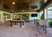 Thumbnail 13 of 37 - a covered patio with a pool table and tables