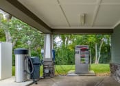 Thumbnail 29 of 37 - a gas pump in front of a green building