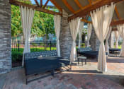 Thumbnail 14 of 37 - a covered patio with couches and curtains