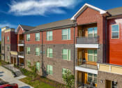 Thumbnail 30 of 32 - an exterior view of a brick apartment building with balconies