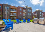 Thumbnail 29 of 32 - our apartments have a large patio with blue chairs and a grill
