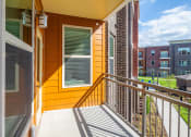 Thumbnail 20 of 32 - the view from the balcony of a home with a yellow wall and a balcony railing