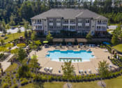 Thumbnail 1 of 36 - an aerial view of an outdoor pool with a building in the background