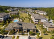 Thumbnail 34 of 36 - an aerial view of a neighborhood with houses and a swimming pool