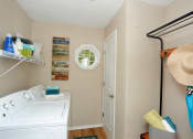 Thumbnail 17 of 18 - a laundry room with a washing machine and a hat on the wall