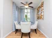 Thumbnail 11 of 18 - a dining room with a ceiling fan and a window