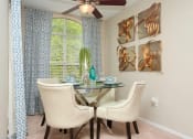 Thumbnail 10 of 18 - a dining room with a table and chairs and a window