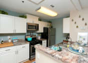Thumbnail 6 of 18 - a kitchen with stainless steel appliances and granite counter tops