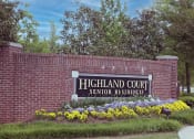 Thumbnail 2 of 30 - a brick retaining wall with a sign for highland court senior residences