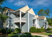 Thumbnail 31 of 31 - a blue house with a balcony and a yard