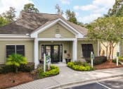 Thumbnail 1 of 31 - the front entrance of a beige house with a sidewalk and trees