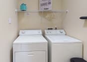Thumbnail 20 of 31 - two washers and a dryer in a laundry room