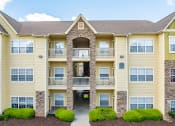 Thumbnail 25 of 29 - the exterior of an apartment building with shrubs