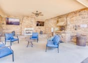 Thumbnail 19 of 29 - a living room with blue chairs and a fireplace