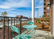 Thumbnail 8 of 27 - the private balcony has a table and two chairs and overlooks the parking lot