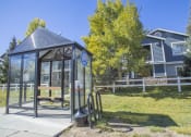 Thumbnail 11 of 43 - a bus stop with a glass shelter in front of a house