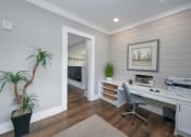 Thumbnail 21 of 54 - a home office with a desk and a plant