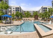 Thumbnail 36 of 49 - High-End Apartments in Decatur, GA - Reserve Decatur - Saltwater Swimming Pool With Sunning Ledges, Umbrellas, Tables and Chairs, and Lush Landscaping.