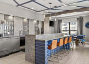 Thumbnail 9 of 49 - a kitchen and dining area in a hotel with blue chairs