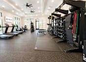 Thumbnail 19 of 35 - A gym with treadmills, weights, and exercise equipment.