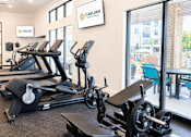 Thumbnail 23 of 35 - A gym with treadmills and exercise equipment.