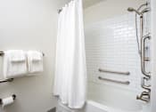 Thumbnail 20 of 25 - A white bathroom with a white shower curtain and a white bathtub.