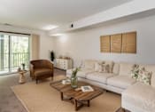 Thumbnail 1 of 26 - A living room with a white couch, a brown armchair, and a wooden coffee table at Winchell Way Apartment , Kalamazoo, 49008