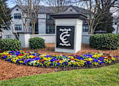 Thumbnail 20 of 20 - A sign with a C on it is in front of a building.