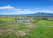 Thumbnail 44 of 45 - A large building complex is surrounded by a green field.