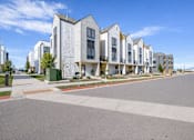 Thumbnail 1 of 45 - A row of modern houses with a clear blue sky above.