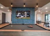 Thumbnail 11 of 47 - a game room with a pool table and a wall mural of a baseball game