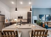 Thumbnail 16 of 47 - an open kitchen and living room with a table and chairs