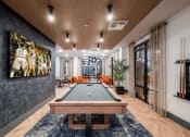 Thumbnail 10 of 47 - a game room with a pool table and a painting on the wall