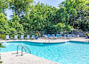 Thumbnail 19 of 33 - a swimming pool with chaise lounge chairs   and trees