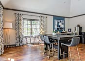 Thumbnail 14 of 33 - a dining room with a table and chairs in front of a window
