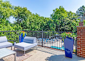Thumbnail 27 of 33 - a balcony with a pool and chairs and a table