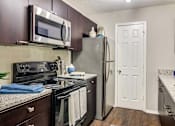 Thumbnail 2 of 33 - a kitchen with stainless steel appliances and a refrigerator