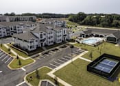Thumbnail 2 of 40 - an aerial view of an apartment complex with a pool and tennis court