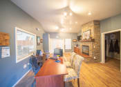 Thumbnail 13 of 43 - the view of a living room with a fireplace and a wooden table
