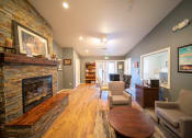 Thumbnail 14 of 43 - a living room with a fireplace and a table and chairs