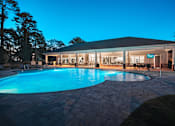 Thumbnail 15 of 31 - A pool in a backyard with a house in the background.